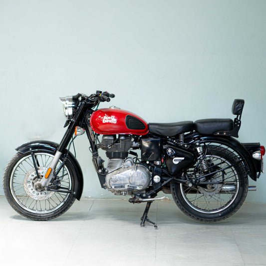 Royal Enfield Classic 350 motorcycle in black with chrome accents, shown from a side angle on a city street.