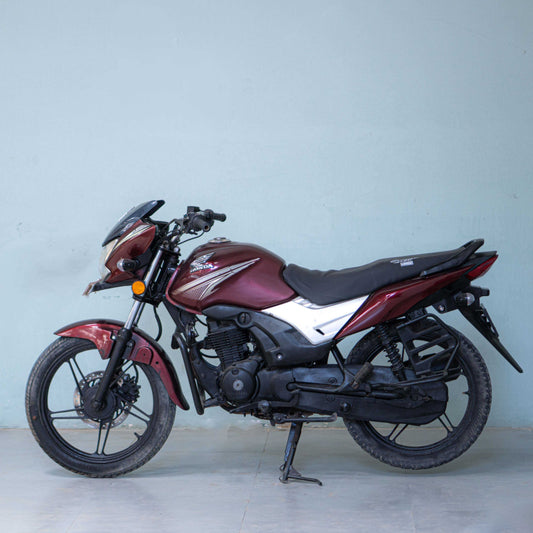 Honda CB Shine 125 motorcycle with sleek design and clear branding, shown in a close-up shot of the bike's side profile.