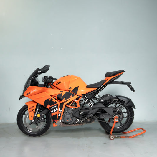 Orange and black KTM motorcycle on a gray background
