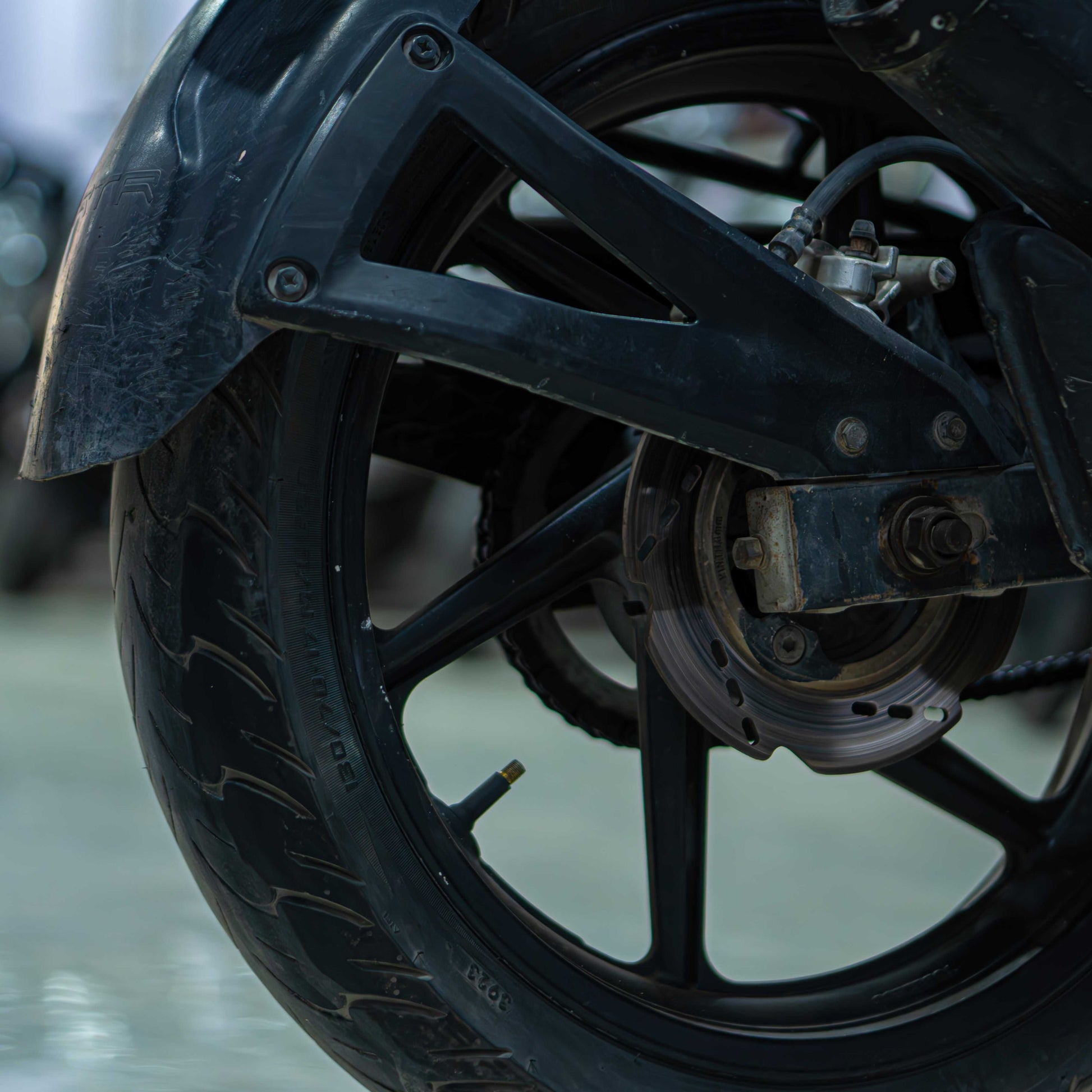Front view of the TVS Apache 160 4V motorcycle with sporty design and sleek black body, parked on a street.