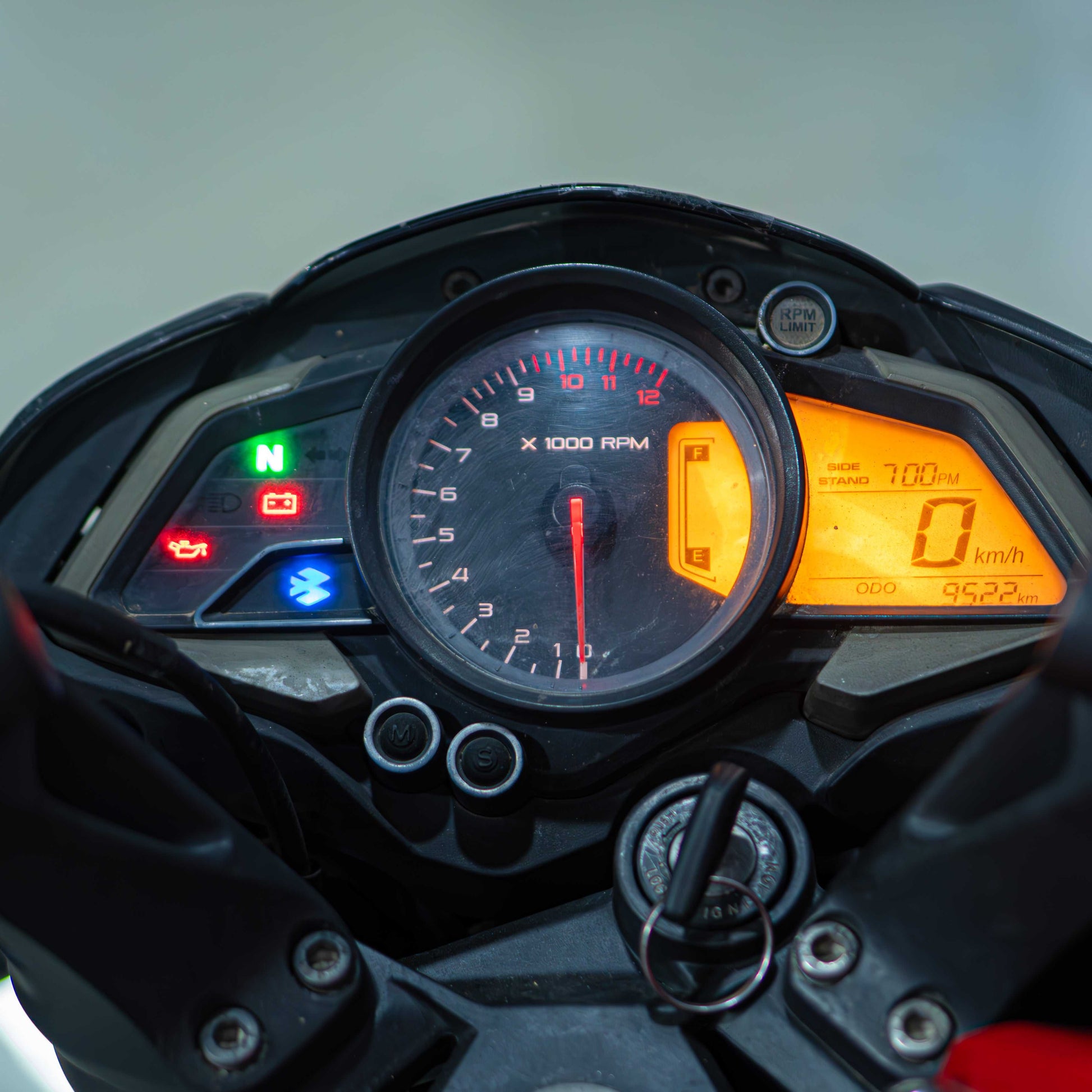 Black Bajaj NS 160 motorcycle with sporty design and sleek body, parked on a city street.