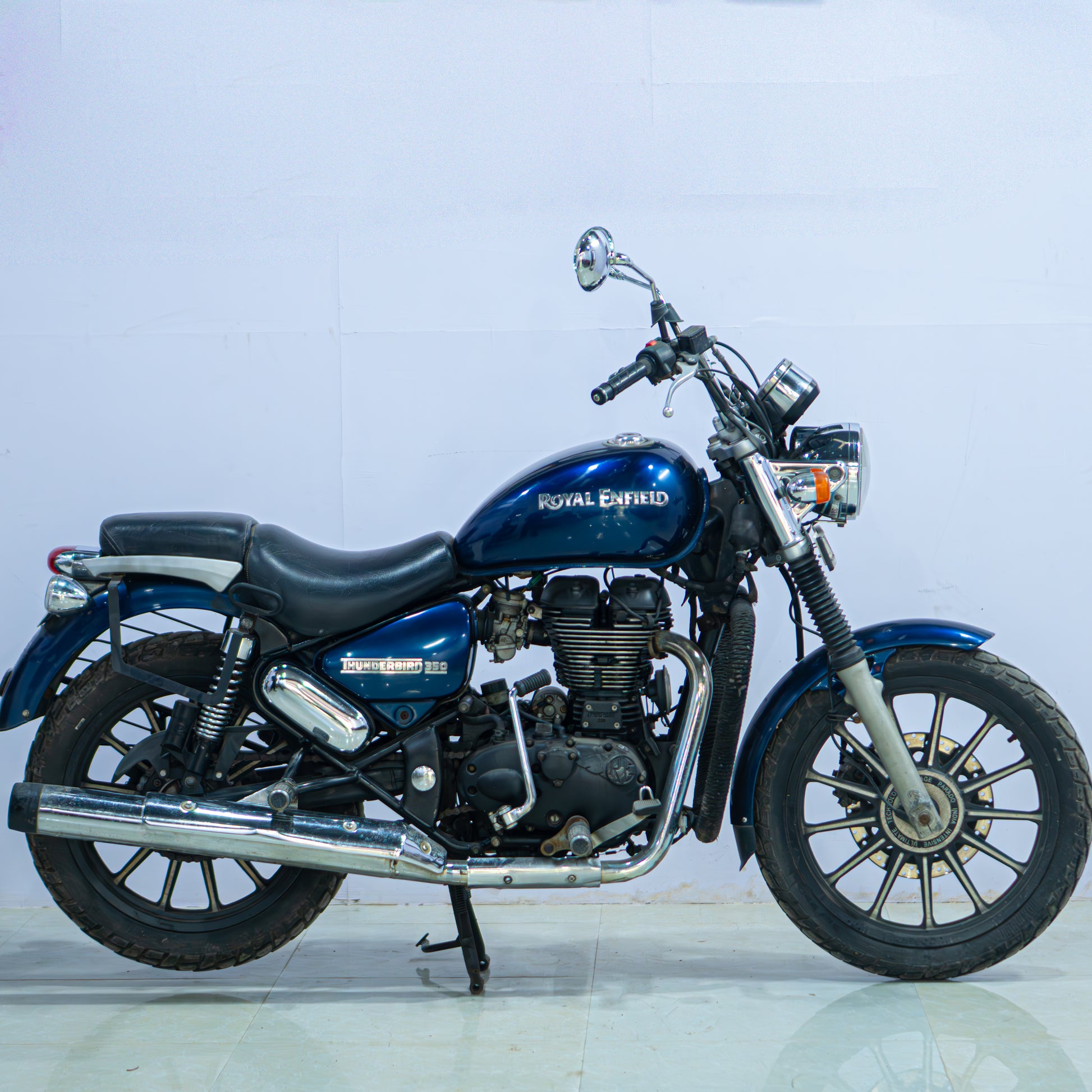 Royal Enfield Thunderbird motorcycle in black with chrome accents, showcasing its classic cruiser design and dual headlights.