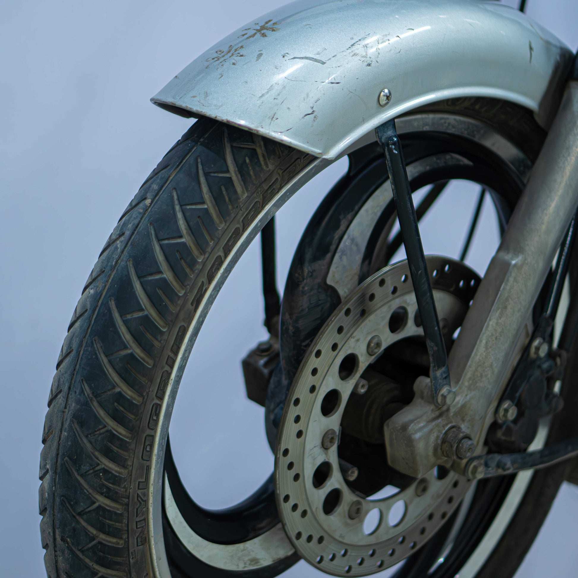 Royal Enfield Classic 350 motorcycle with chrome accents and vintage design, parked on a scenic road.