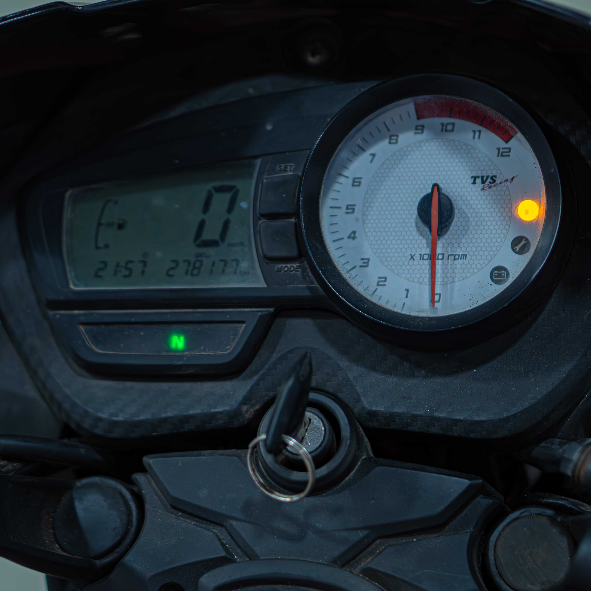 Black TVS Apache 160 motorcycle with sporty design and sleek body, parked on a street.