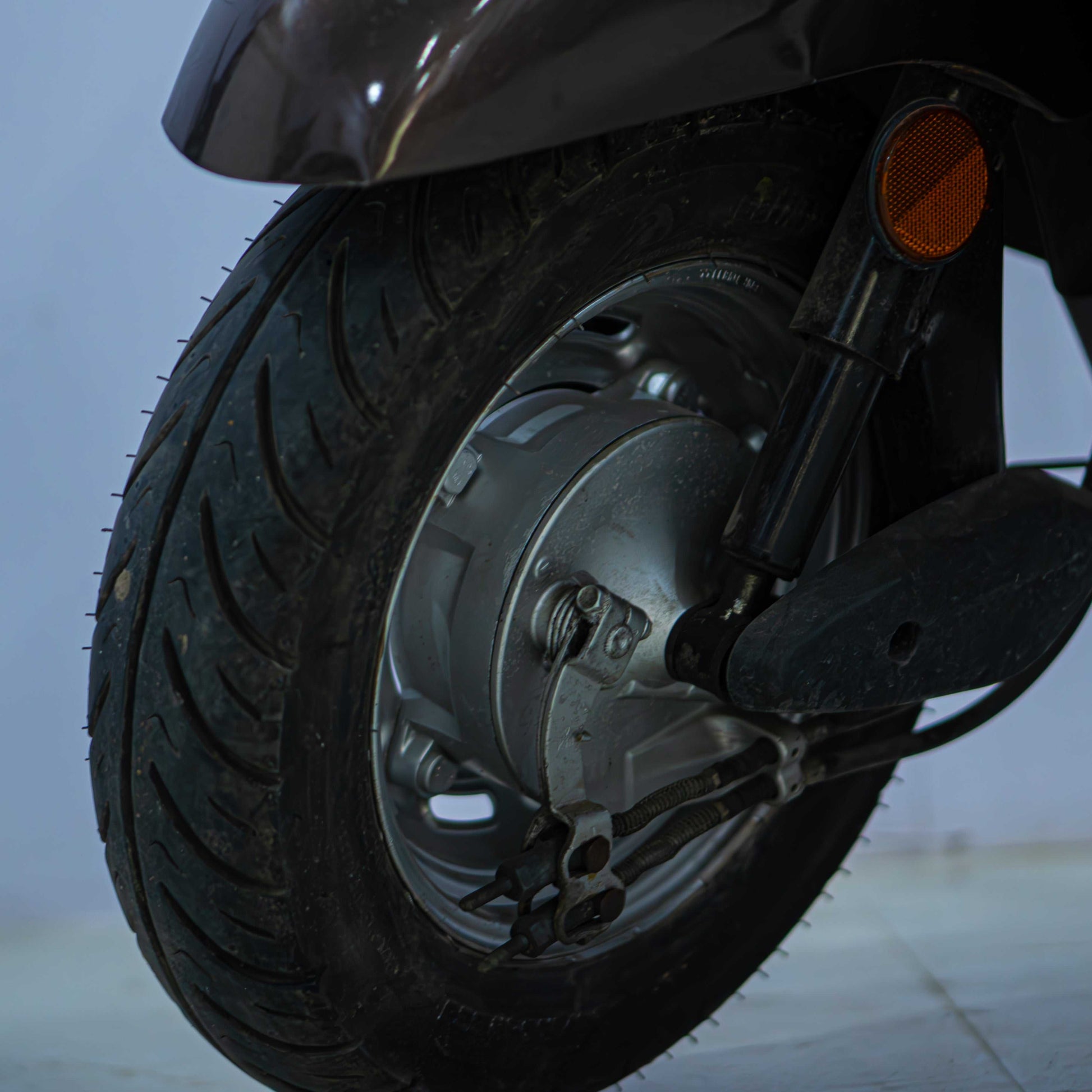 Honda Activa 5G scooter with black body and silver accents, parked on a street showing front and side views.