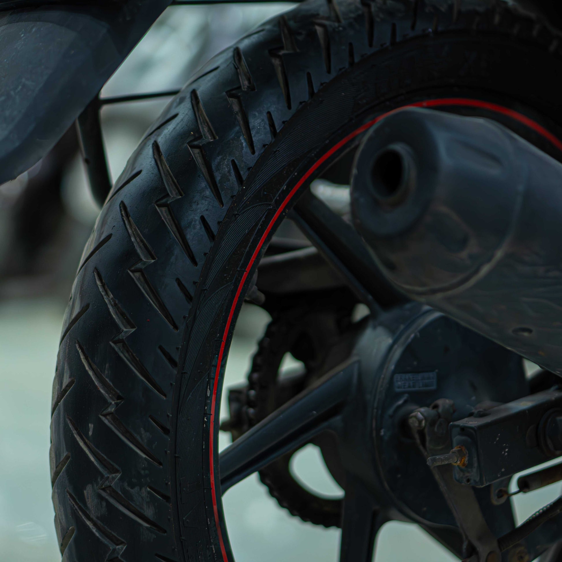 Red TVS Apache 160 motorcycle parked on a road, showcasing its sporty design and sleek bodywork.