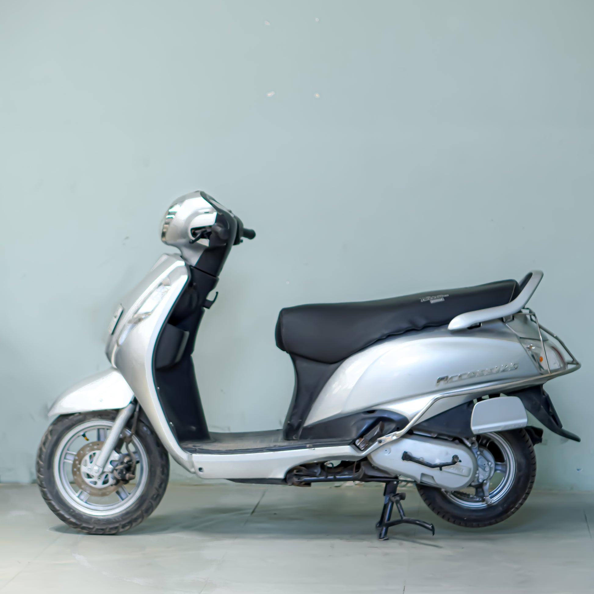 Used Suzuki Access 125 silver left side view in Gurgaon family scooter good condition