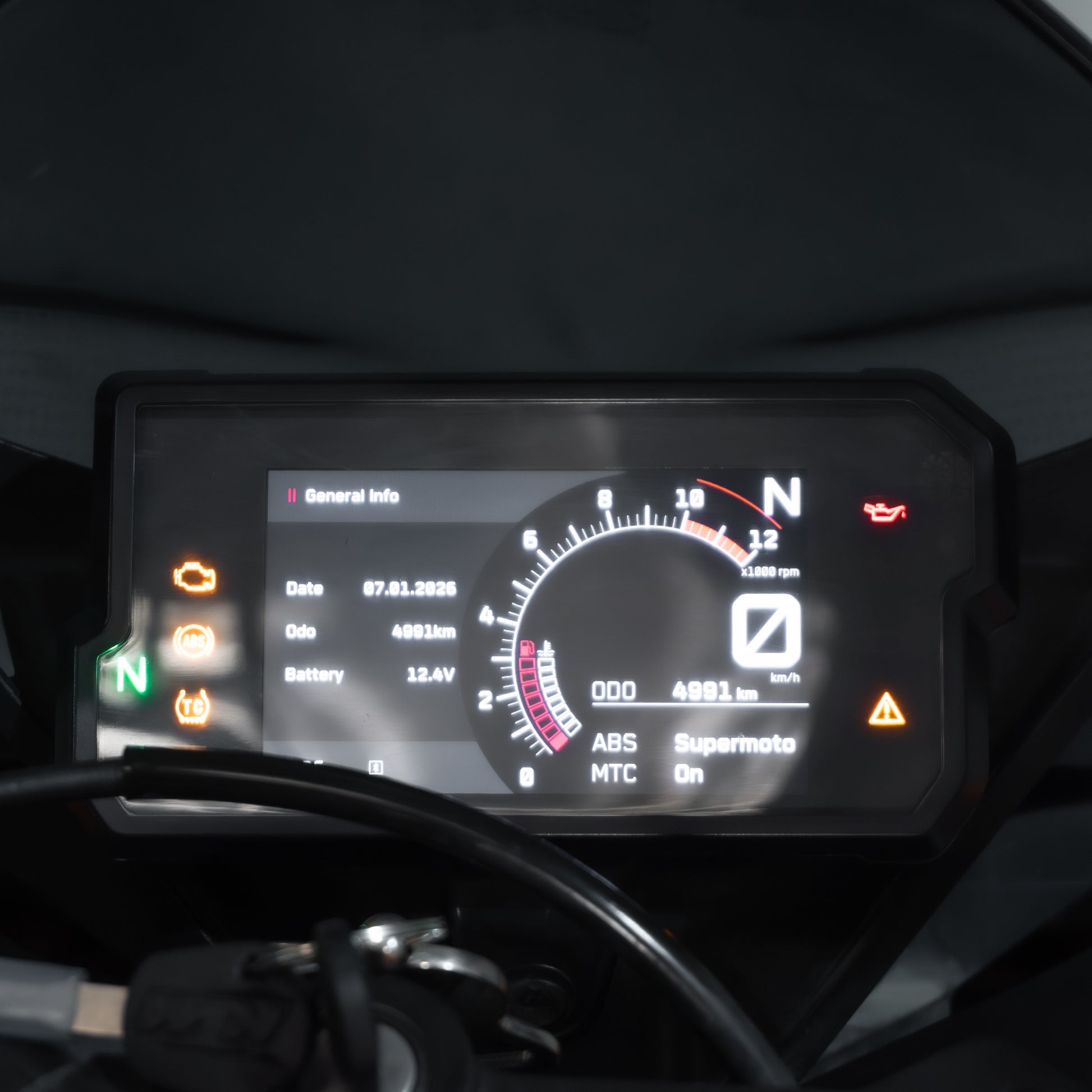 Digital dashboard display of a motorcycle with various indicators and information.