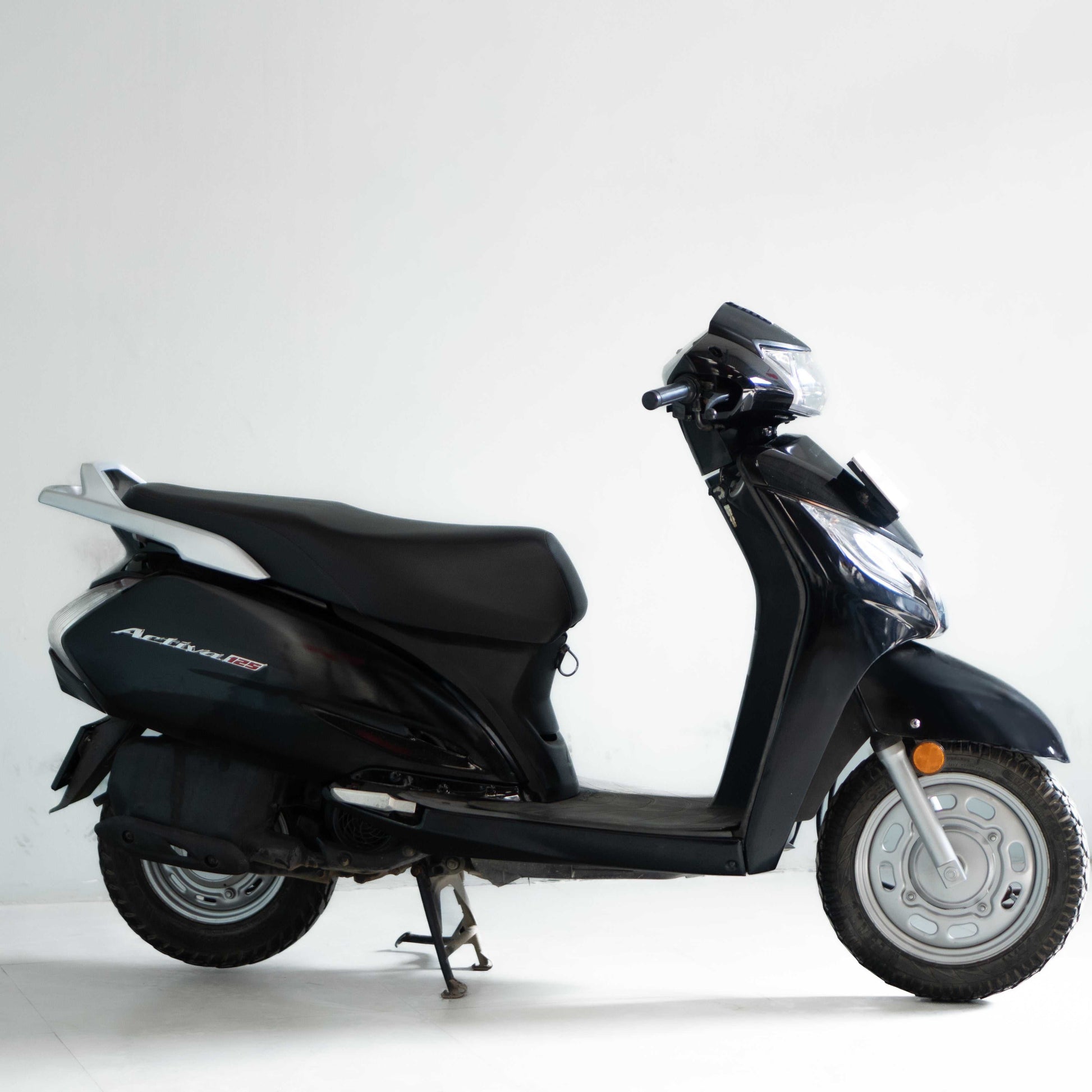 Black scooter on a white background used in gurgaon