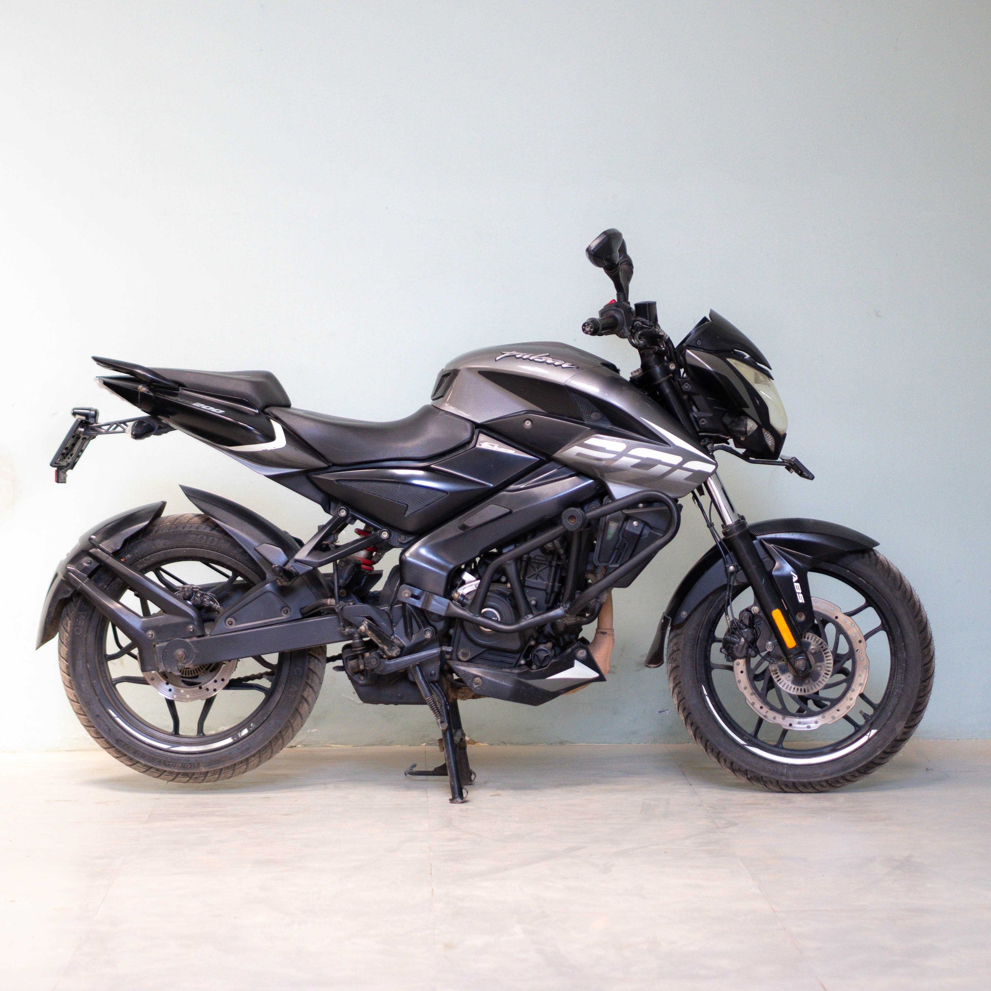 Black motorcycle on a light gray background