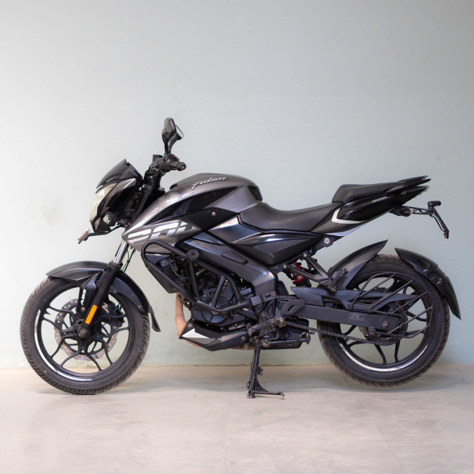 Black motorcycle on a light gray background