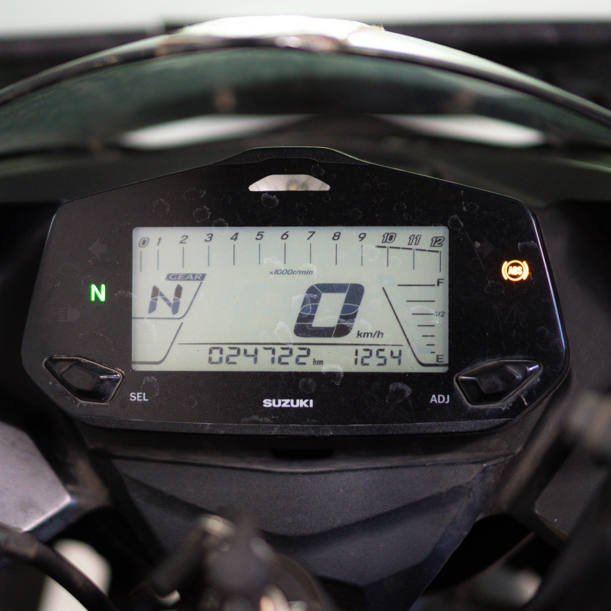 Close-up of a Suzuki motorcycle dashboard with digital display and speedometer. Suzuki Gixxer SF 150 Used Bike for Sale in Gurgaon