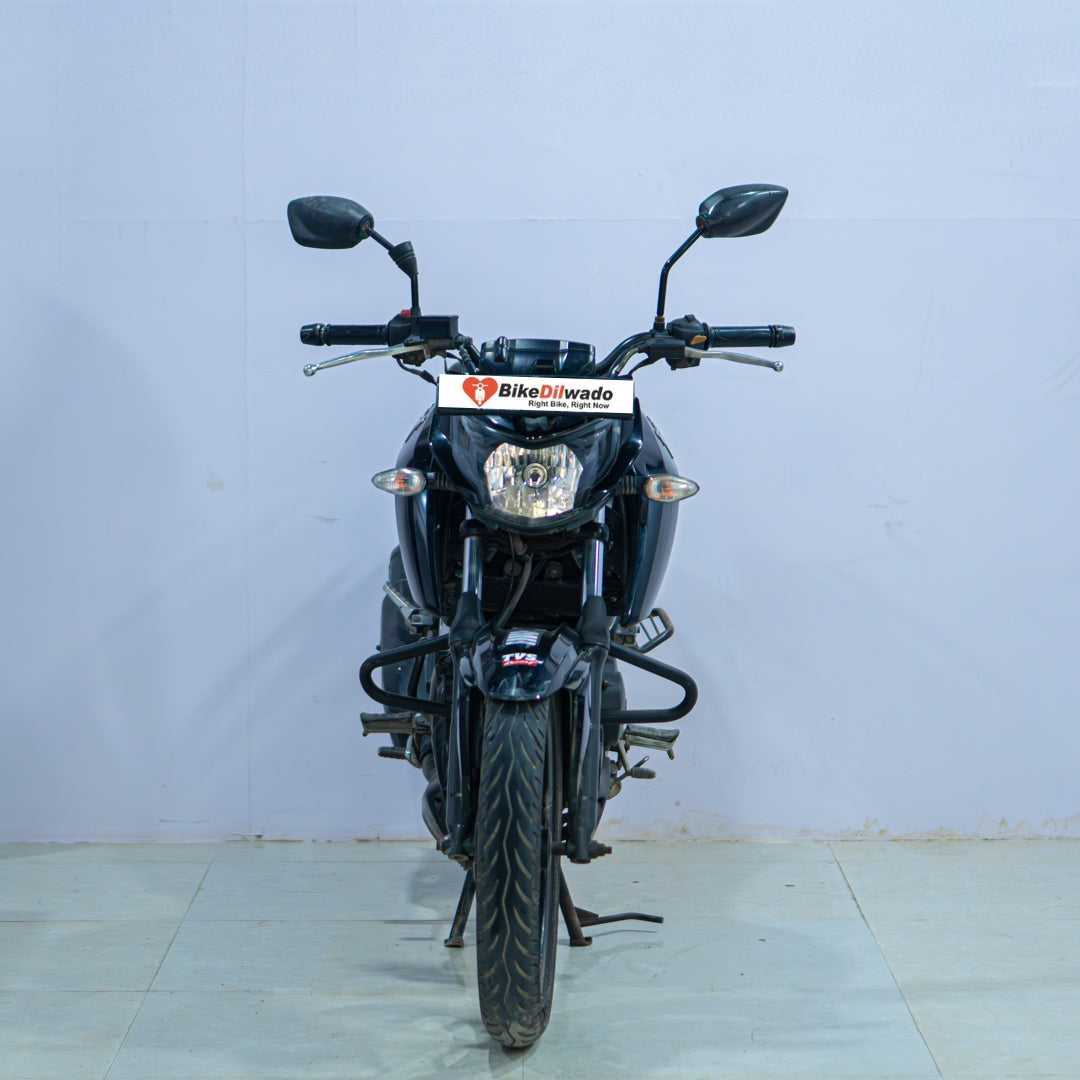 TVS Apache 160 4V motorcycle displayed with sleek black body and sporty design, showcasing the BikeDilwado branding.