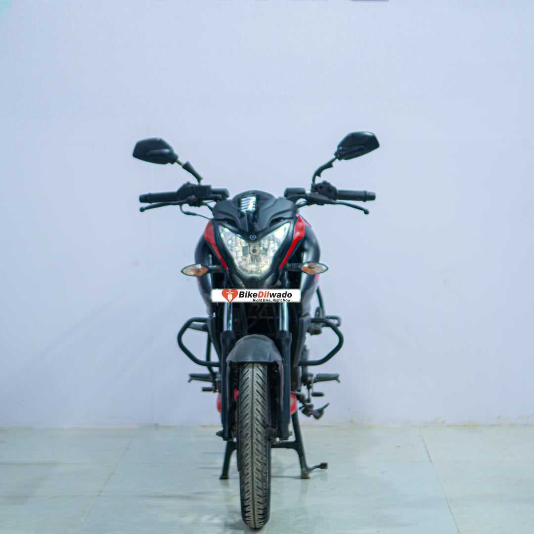Bajaj NS 160 motorcycle in black with sporty design and sleek body, displayed on a stand against a plain background.
