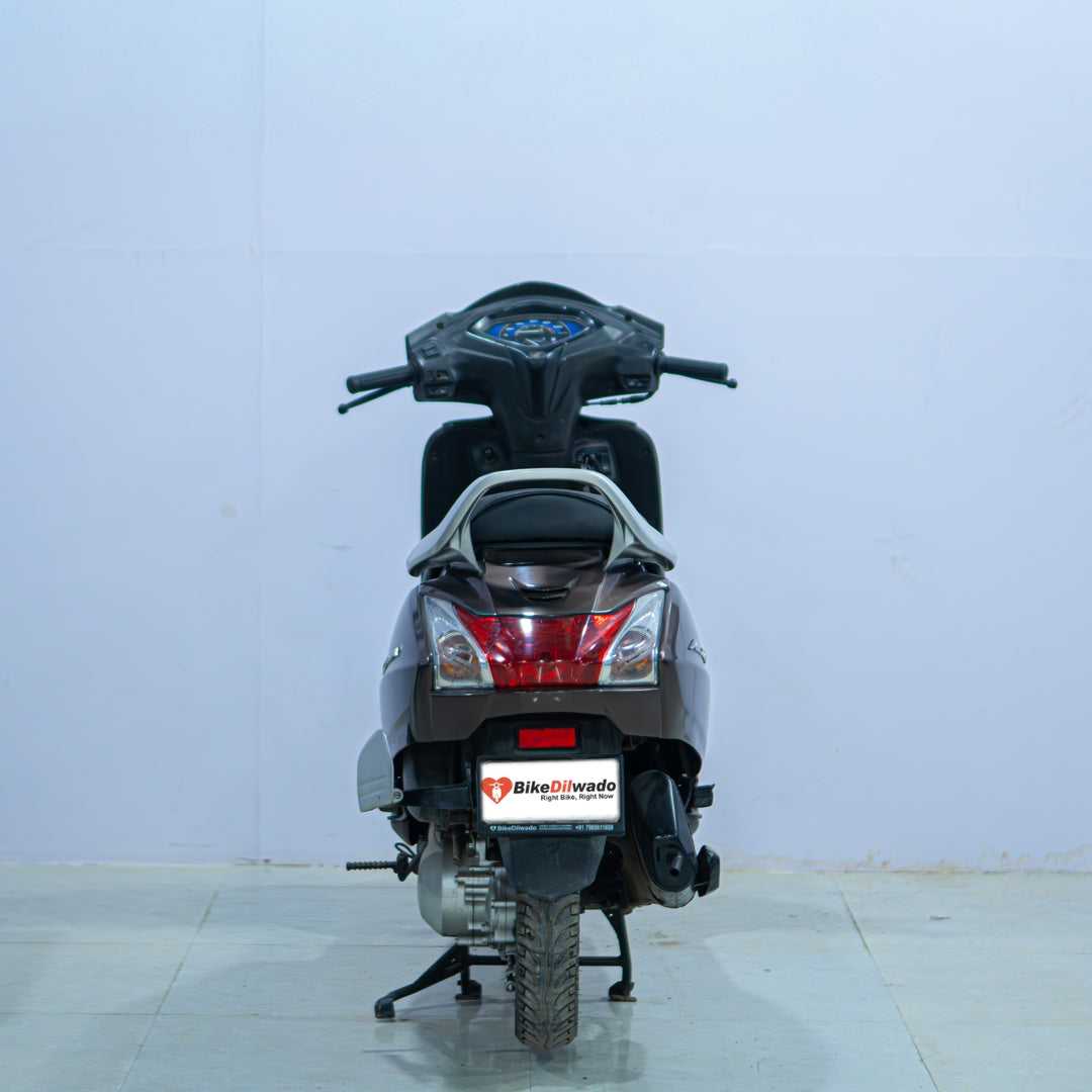 Honda Activa 5G scooter in black, showing the front view with headlight, handlebar, and side mirrors.