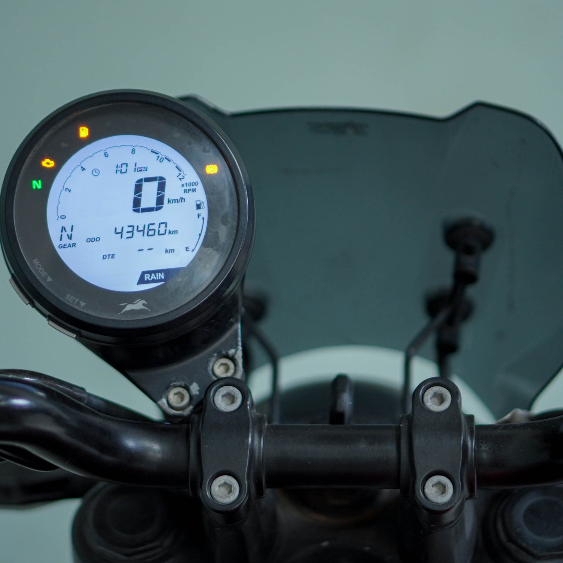 TVS Ronin motorcycle parked outdoors, showcasing its sleek design and modern features in a clear, detailed image.