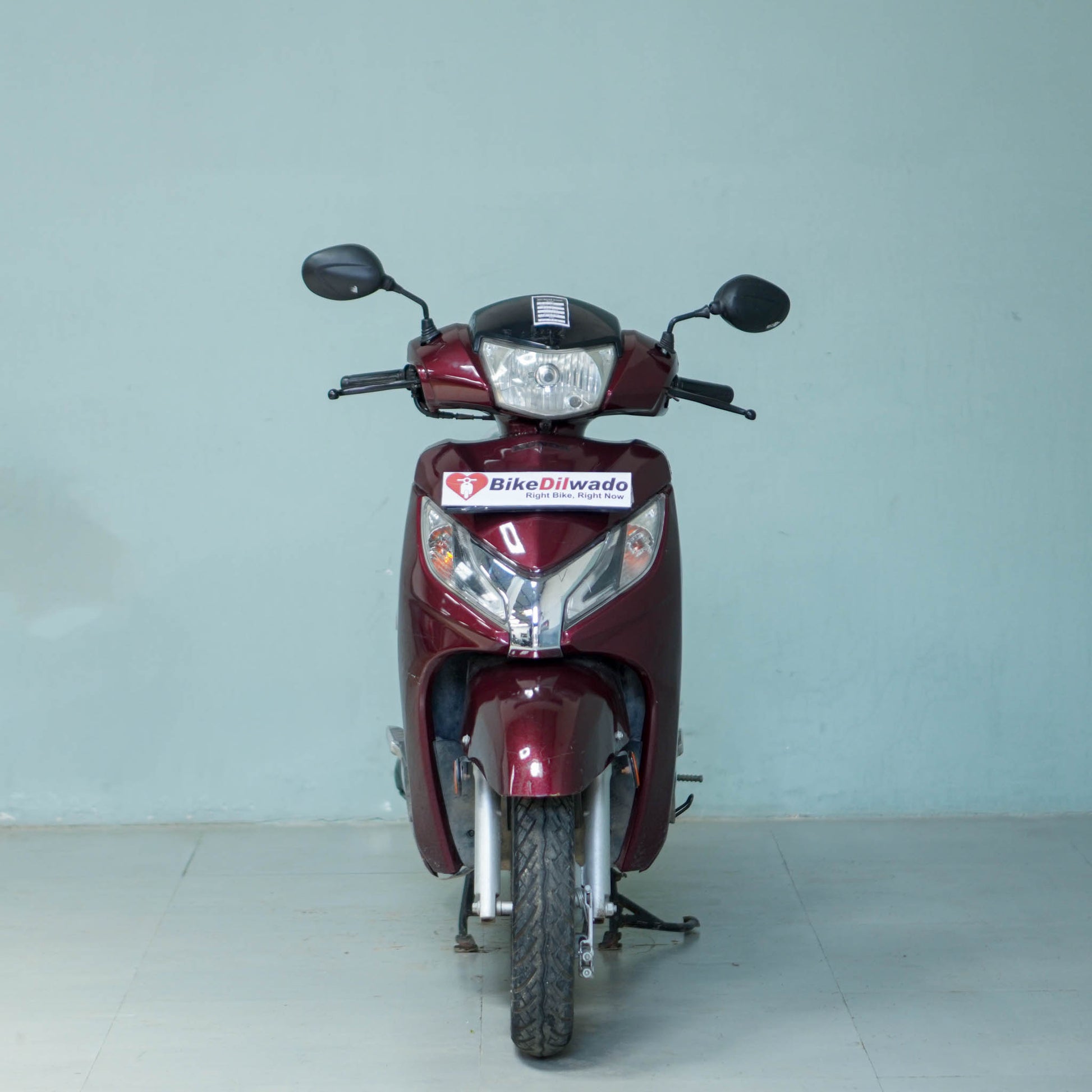 Honda Activa 125 scooter with black body and silver accents, featuring a comfortable seat and modern design.