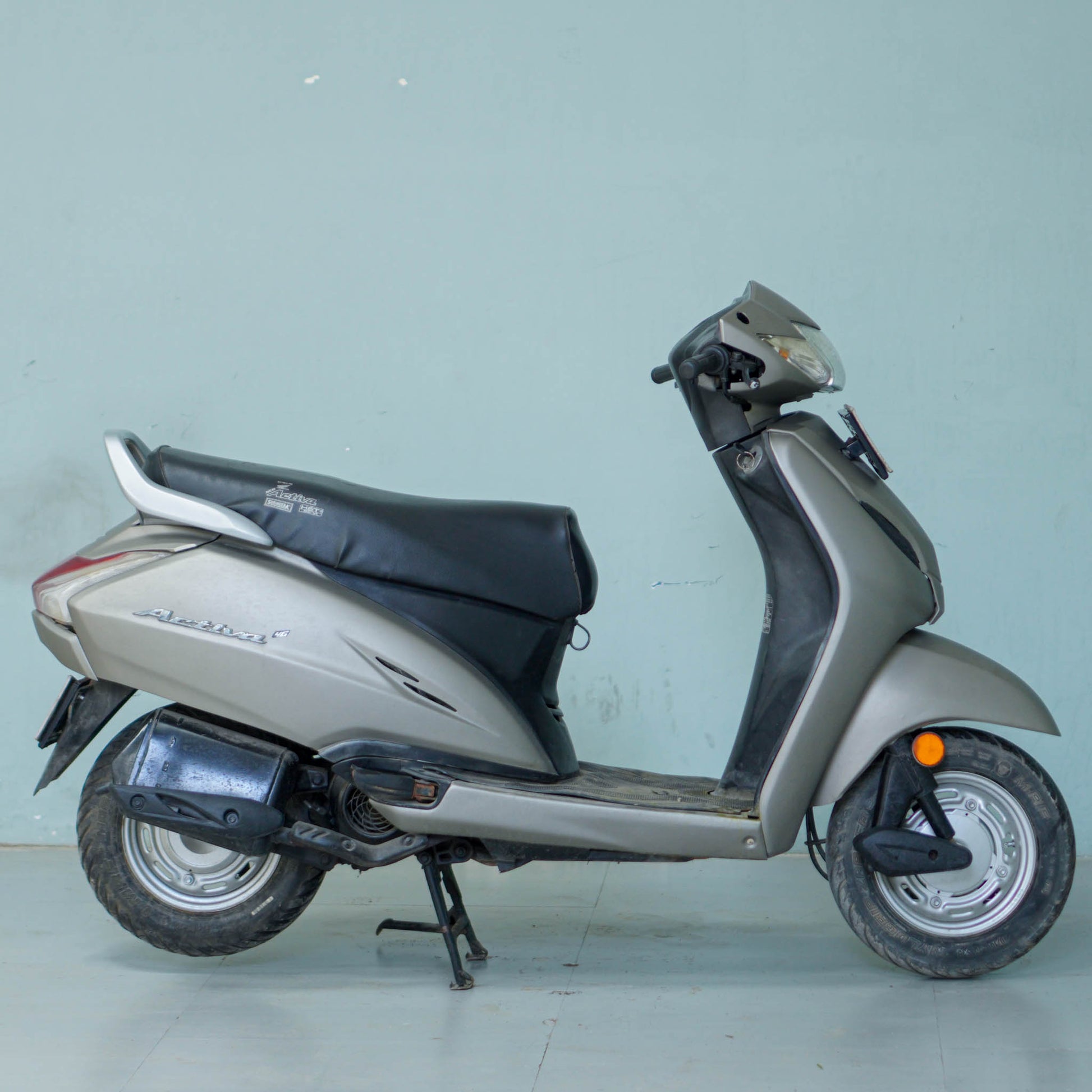 Honda Activa 4G scooter in blue color with front view, featuring sleek design and modern headlights.