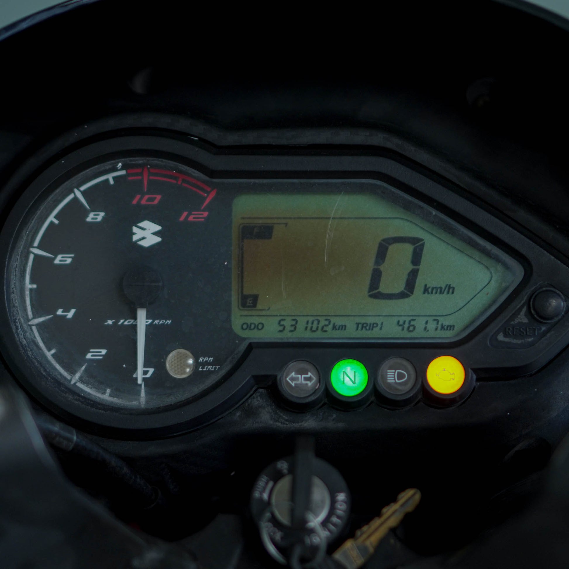 Black Bajaj Pulsar 125 motorcycle with sporty design and alloy wheels, parked on a city street.