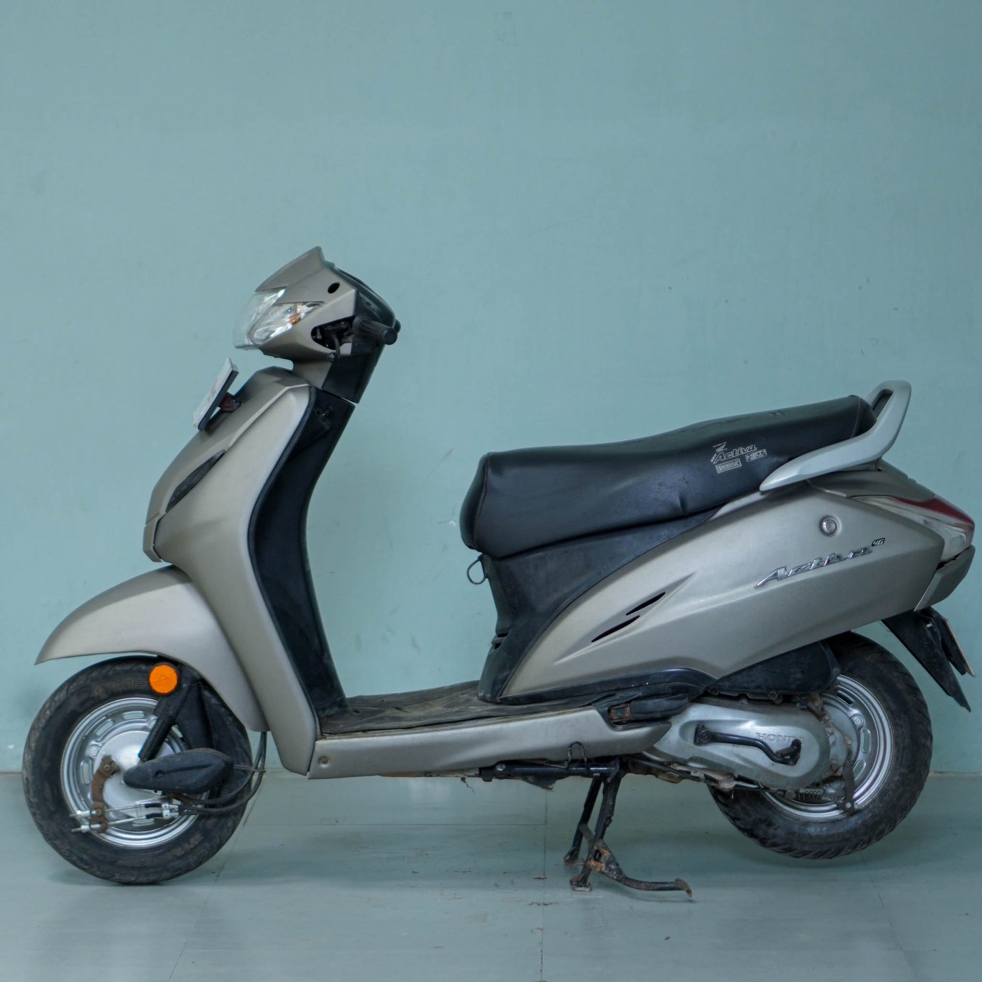 Honda Activa 4G scooter parked on a city street, showcasing its sleek design and modern features.