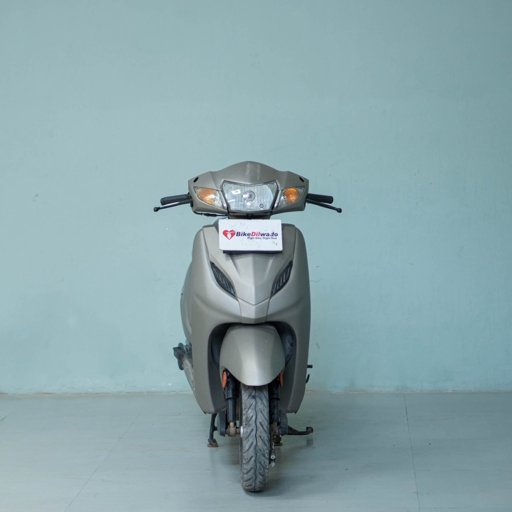 Honda Activa 4G scooter in black color with front and side view, showcasing its design and features.