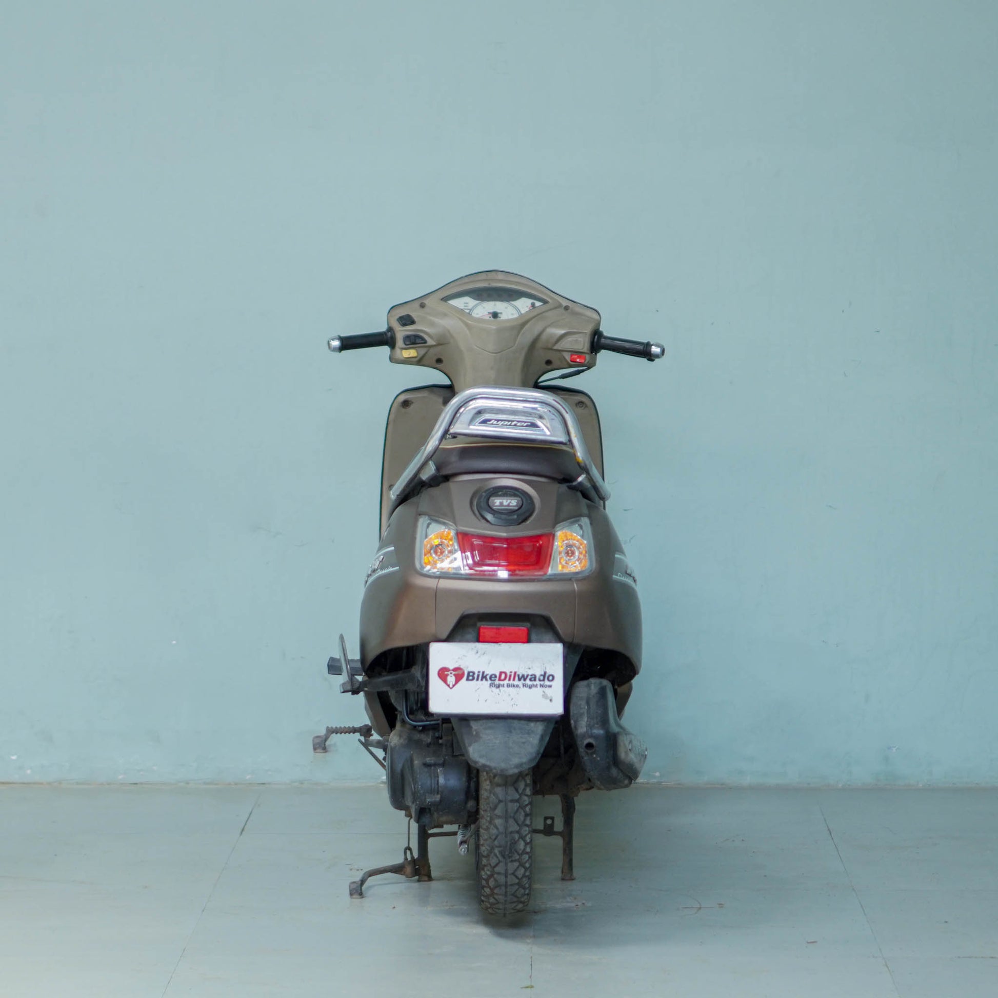 Silver TVS Jupiter Classic scooter with black seat and alloy wheels, showcasing the stylish design and comfortable riding posture.