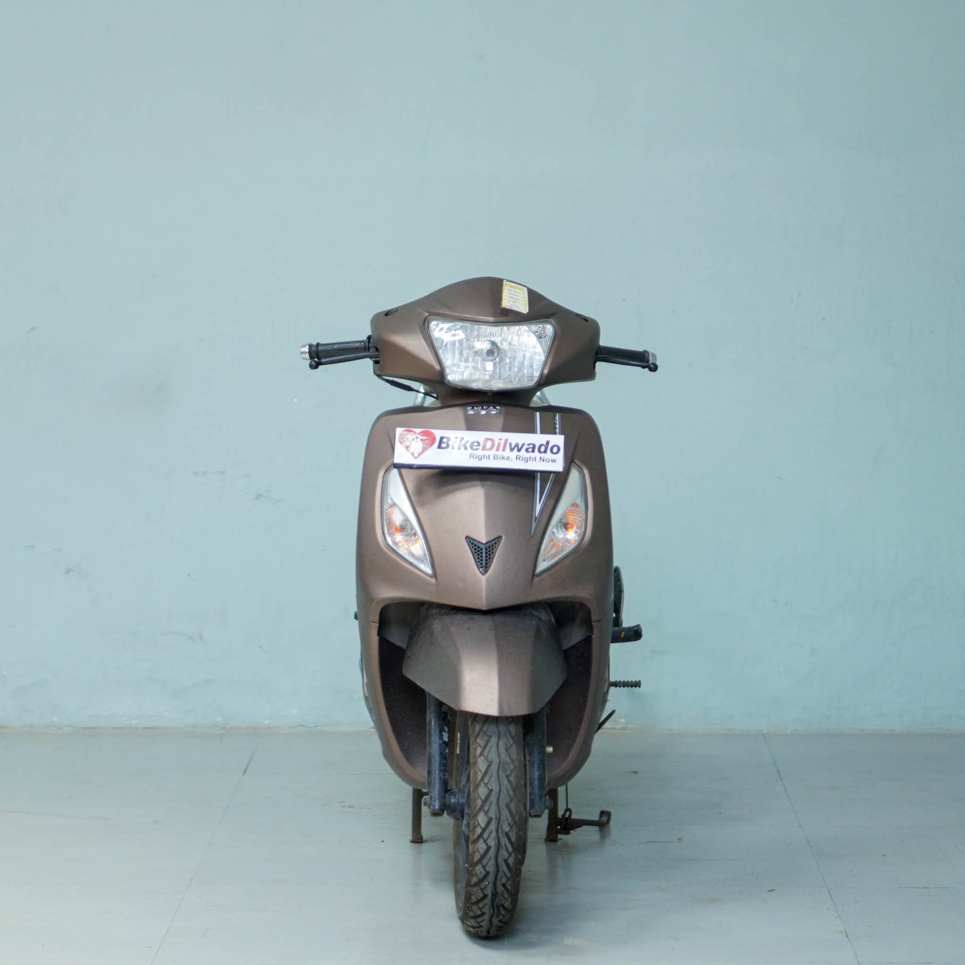 TVS Jupiter Classic scooter with black seat and silver body, featuring stylish design and front headlight, by BikeDilwado.