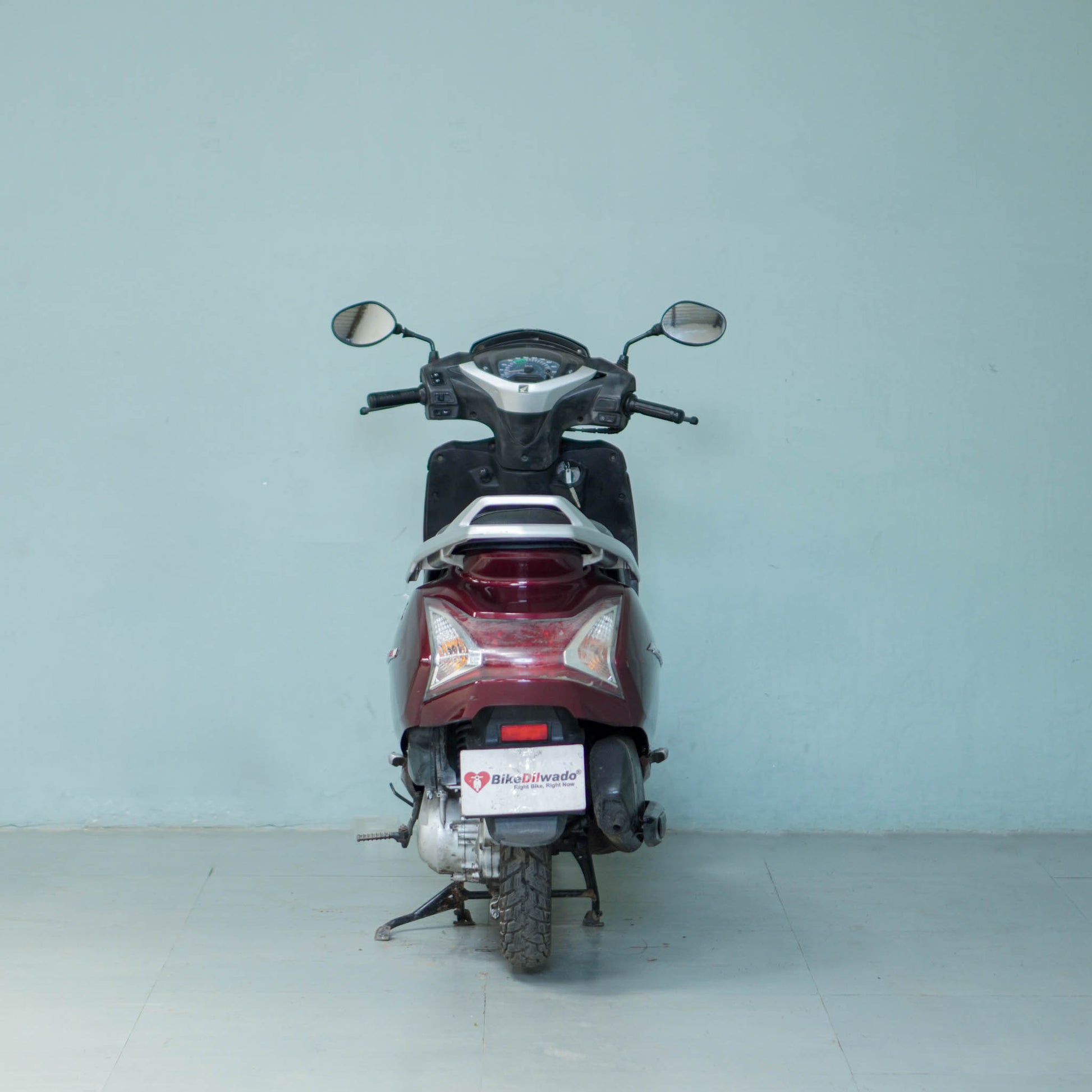 Honda Activa 125 scooter with black seat and modern design, parked on a city street.