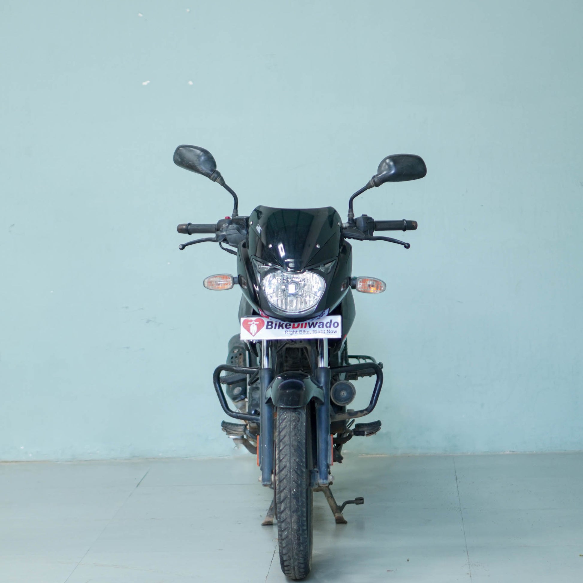 Bajaj Pulsar 125 motorcycle by BikeDilwado, showcasing the sleek black and red design with sporty features and modern headlights.