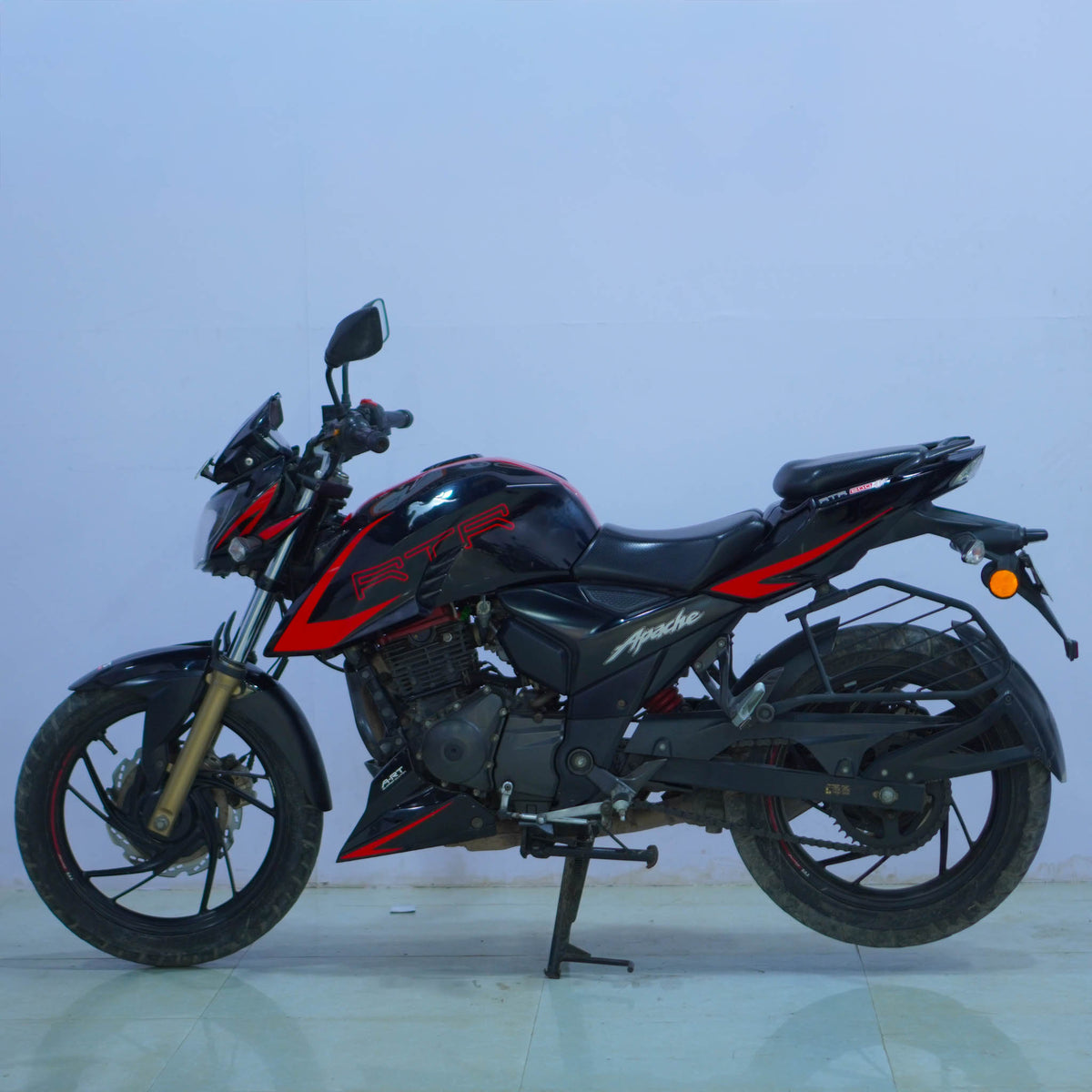 TVS Apache 200 4V motorcycle with sporty design and sleek black finish, showcasing the bike's front and side view.