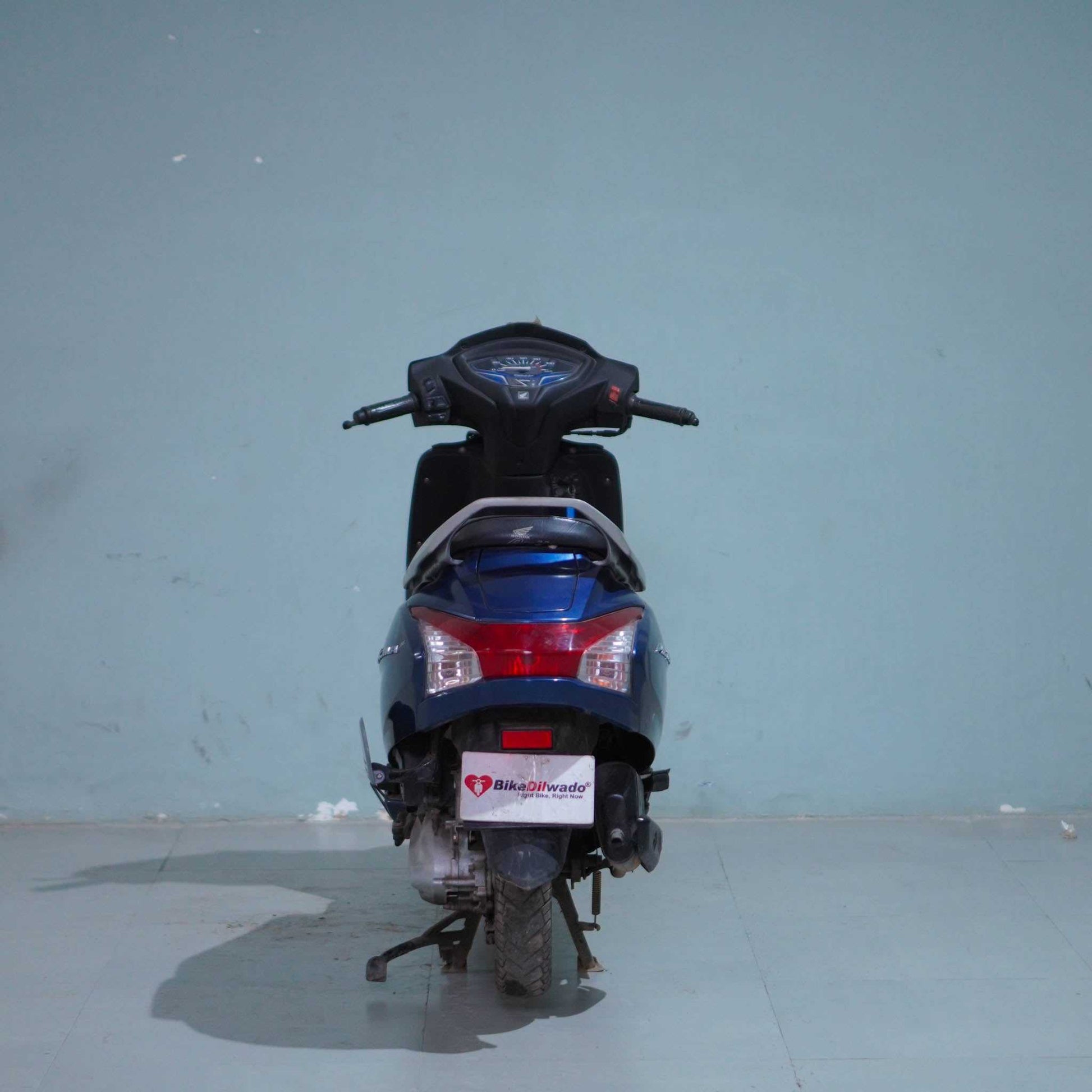 Honda Activa 6G scooter in black color with front view, showing the headlight, handlebars, and sleek body design.