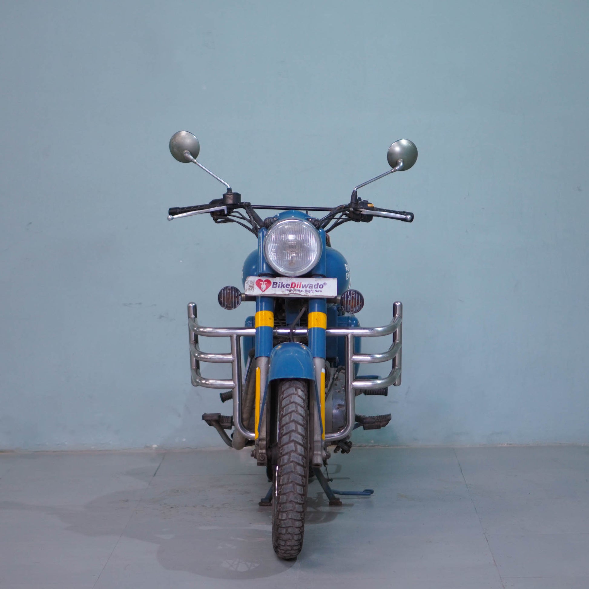 Royal Enfield Classic 500 motorcycle with black and chrome finish, featuring a vintage design and twin exhaust pipes.