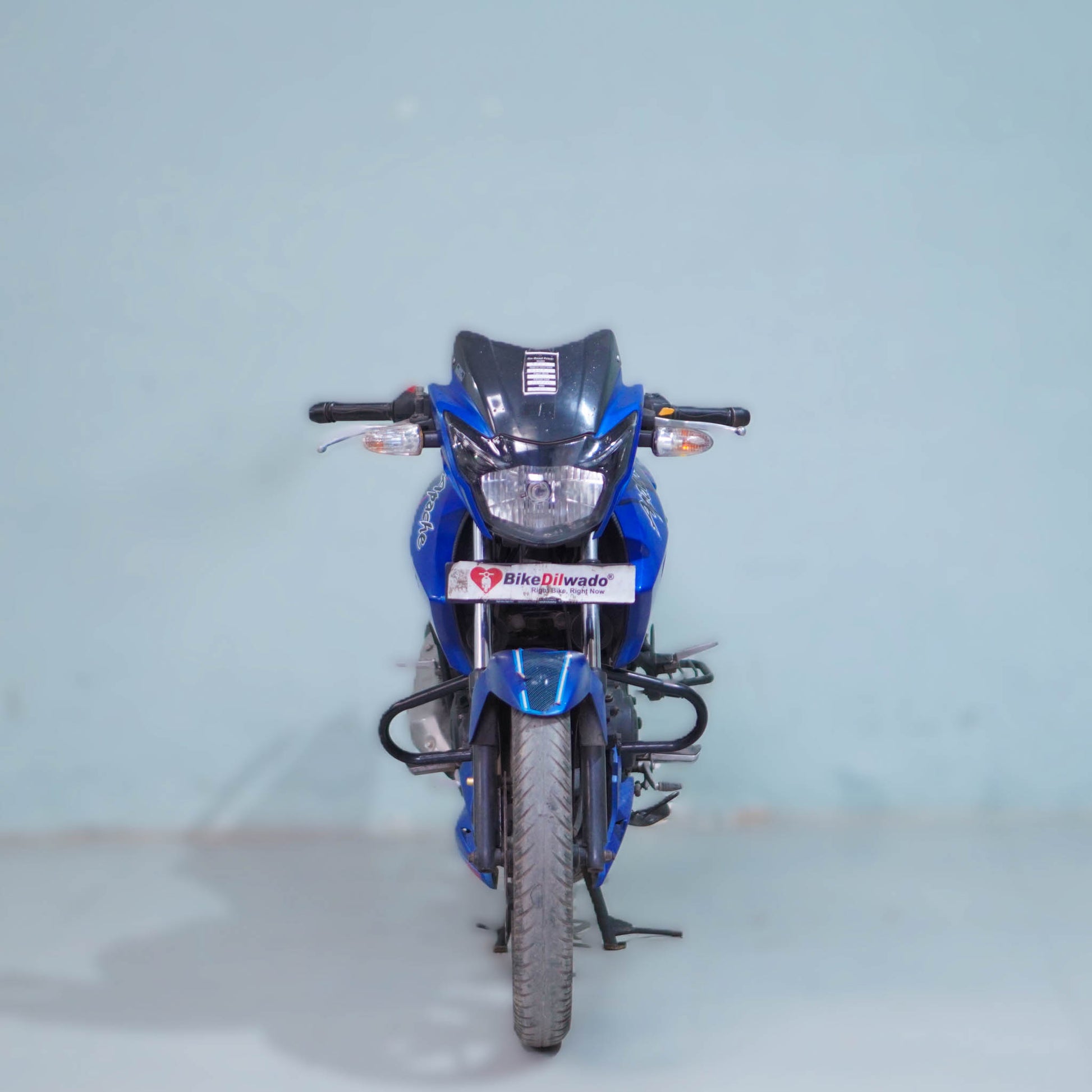 TVS Apache 160 motorcycle from BikeDilwado, showing the sleek black and red design and detailed front view.