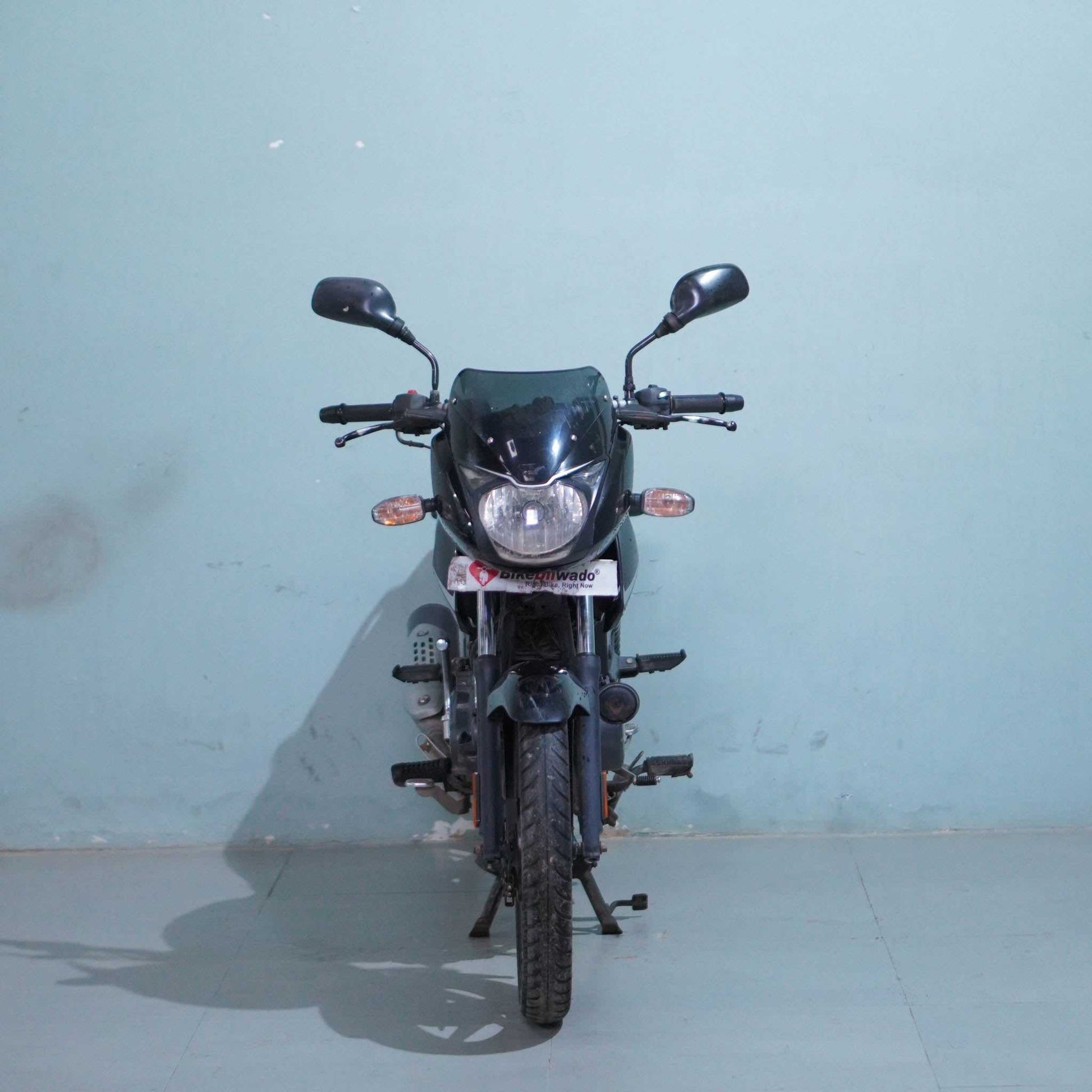 Bajaj Pulsar 125 motorcycle in black with sporty design, featuring sleek headlights and stylish bodywork by BikeDilwado