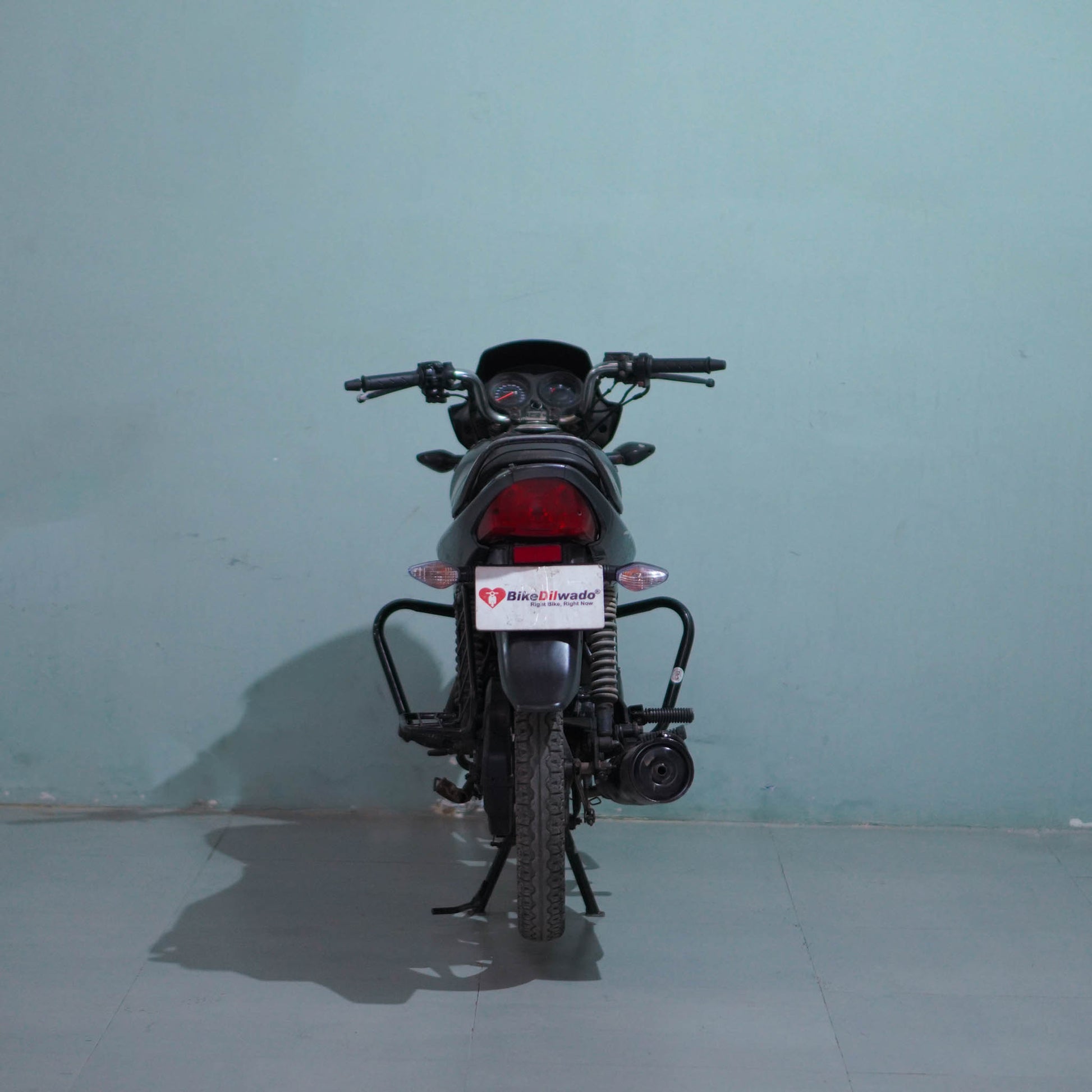 Honda Shine 125 motorcycle from BikeDilwado, showing the sleek black and chrome design with front view and detailed engine features.