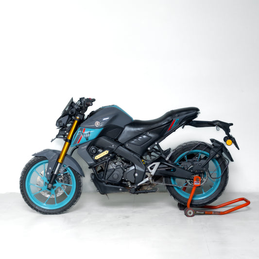 used mt 15 gurgaon Black motorcycle with blue wheels on a white background